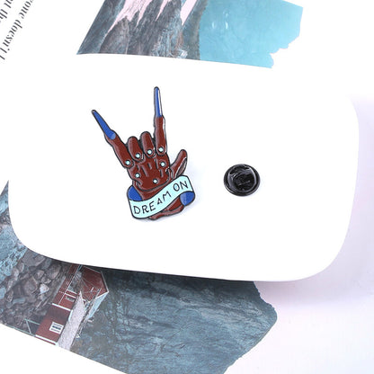 Rock band gesture brooch