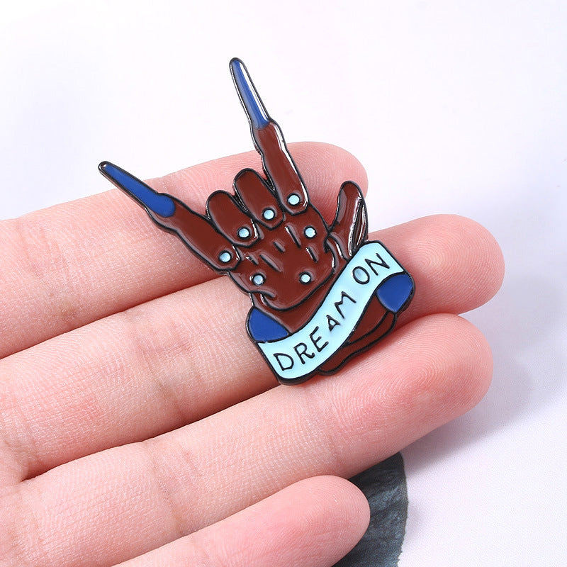 Rock band gesture brooch